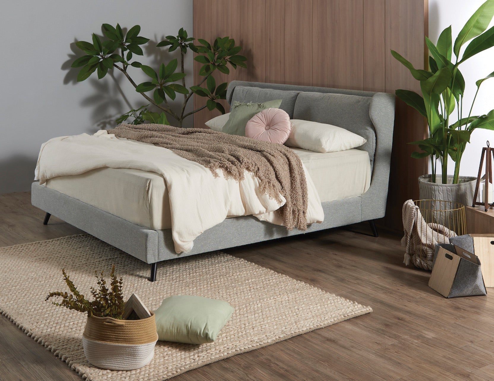 Bed frame and mattress matching a cosy green room.
