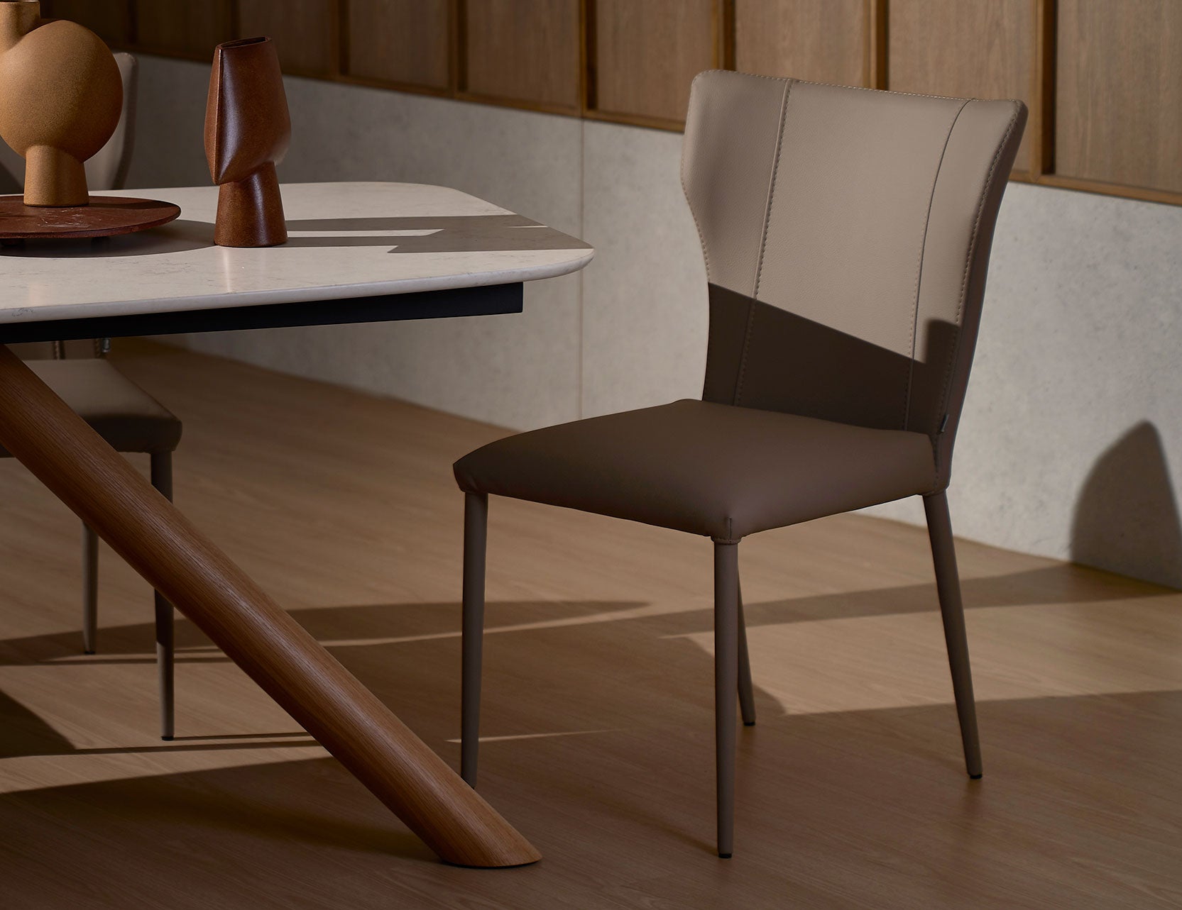 Foil leather dining chair featuring a sleek contemporary form