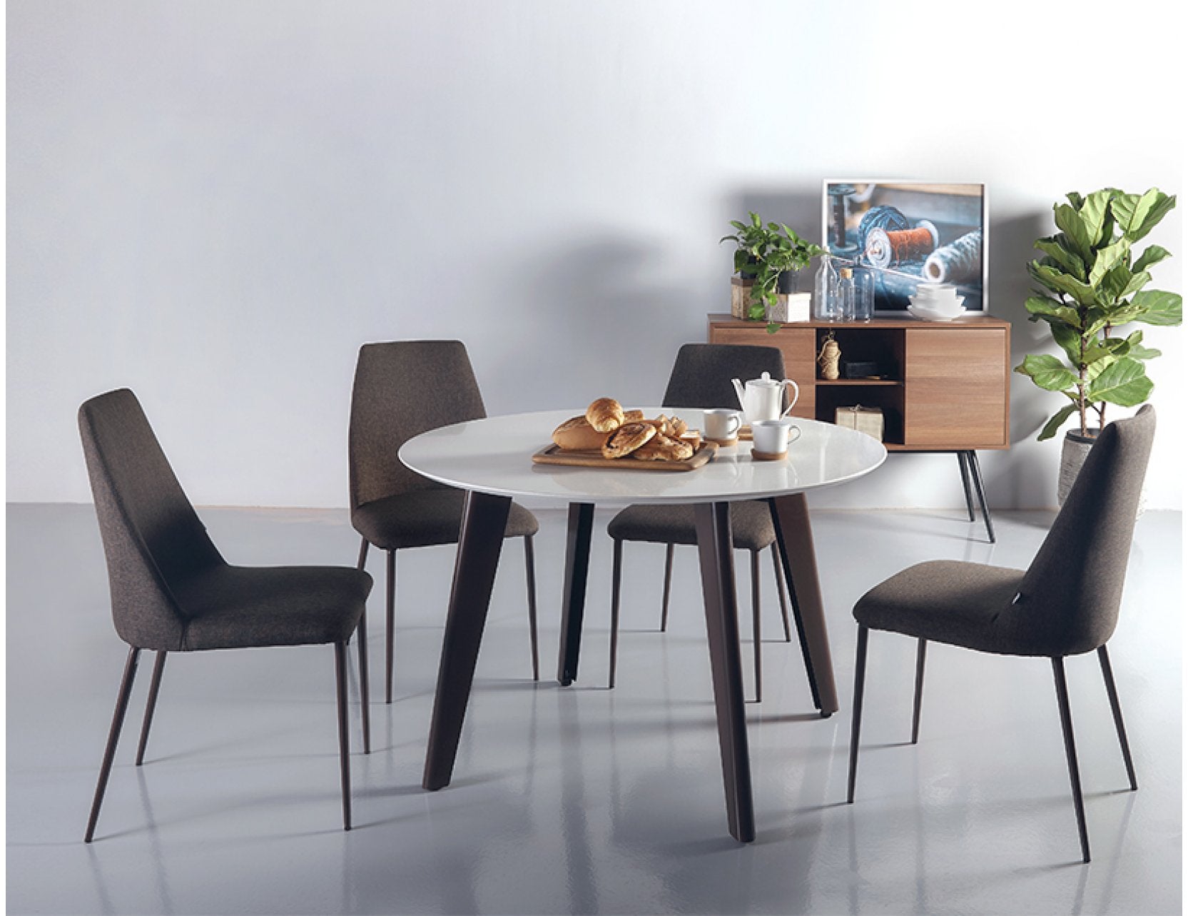 Kay round quartz dining table shown in a dining setting